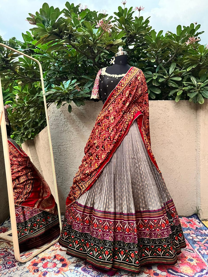 Beige & Black Lehenga with Bandani Patola at myriti. So, why wait? Head over to www.myriti.com and make it yours today. Trust us, you're going to look absolutely stunning!
