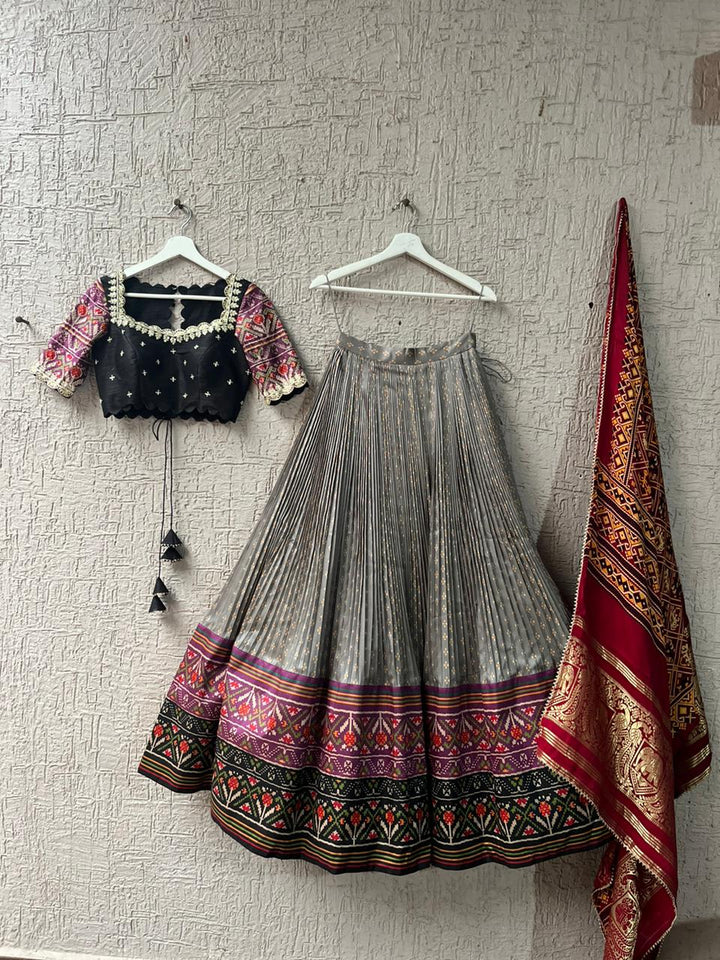 Beige & Black Lehenga with Bandani Patola at myriti. So, why wait? Head over to www.myriti.com and make it yours today. Trust us, you're going to look absolutely stunning!