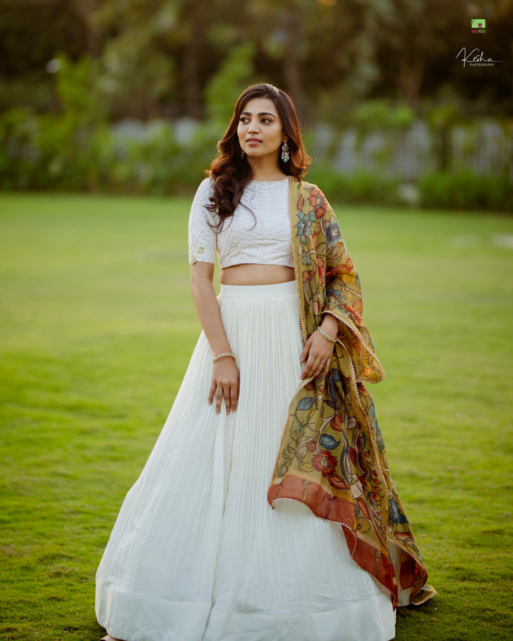 Elegant White Lehenga paired with a vibrant Kalamkari Dupatta, a perfect fusion of modern style and traditional art, available exclusively at MyRiti.