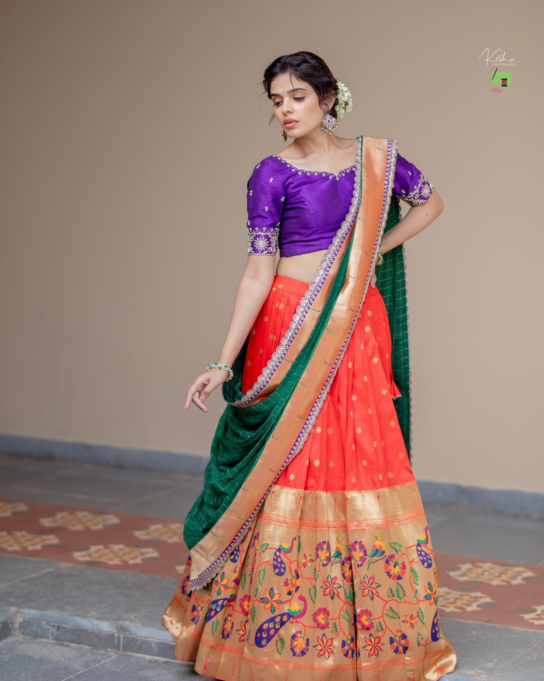 Radiant Red Paithani Lehenga, adorned with exquisite patterns, available at www.myriti.com. A perfect blend of traditional elegance and modern style, ideal for those who love the timeless beauty of Paithani Lehengas.