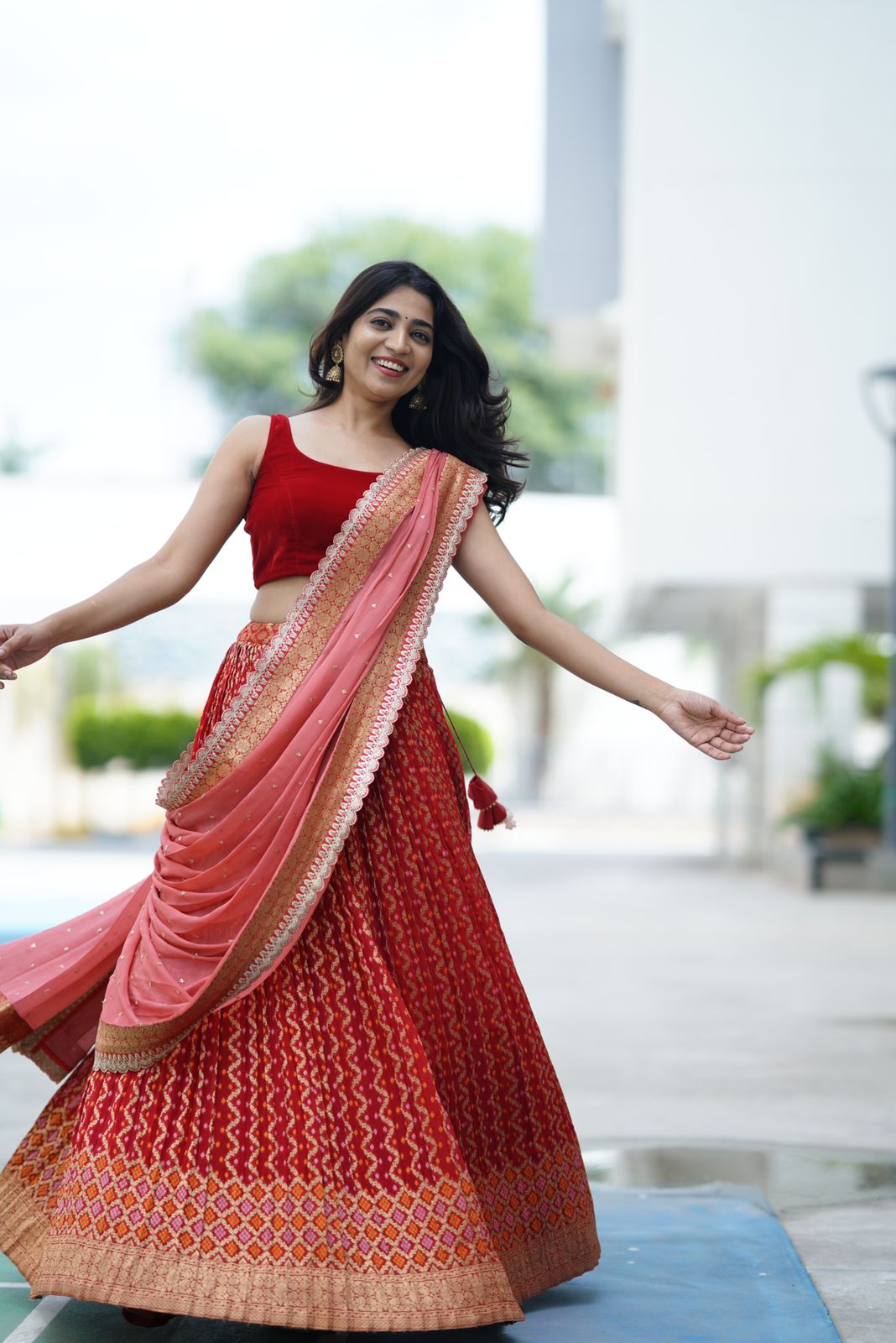 Alternative style of Red Bandani Lehenga showcased, offering a fresh take on classic red with unique patterns and design elements