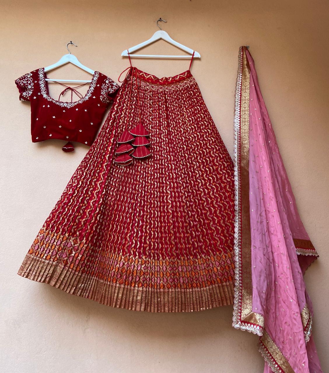 Bold Red Bandani Lehenga by myRiti, exemplifying rich red tone with elaborate Bandani patterns, ideal for making a statement at traditional events