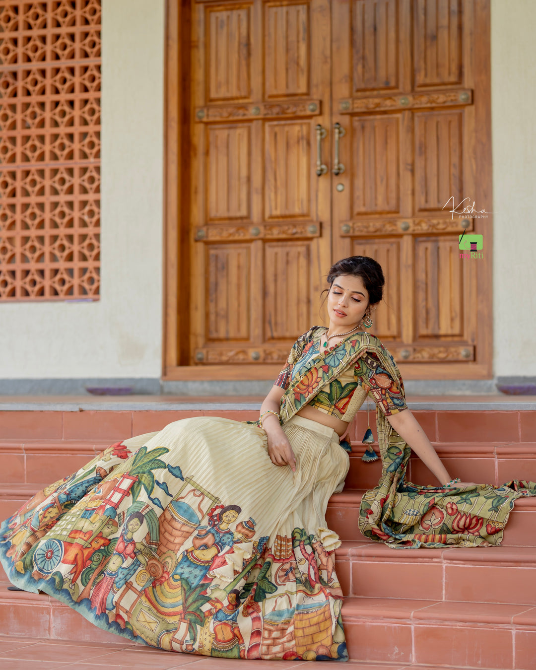 Elegant Cream Kalamkari Lehenga featuring traditional hand-painted designs, available at www.myriti.com. Perfect blend of classic art and modern fashion.