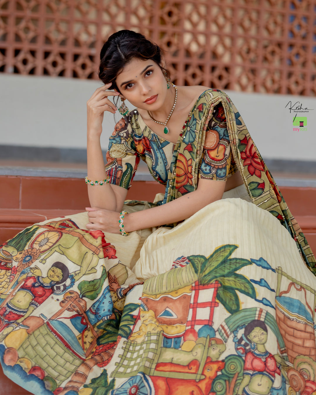 Elegant Cream Kalamkari Lehenga featuring traditional hand-painted designs, available at www.myriti.com. Perfect blend of classic art and modern fashion.