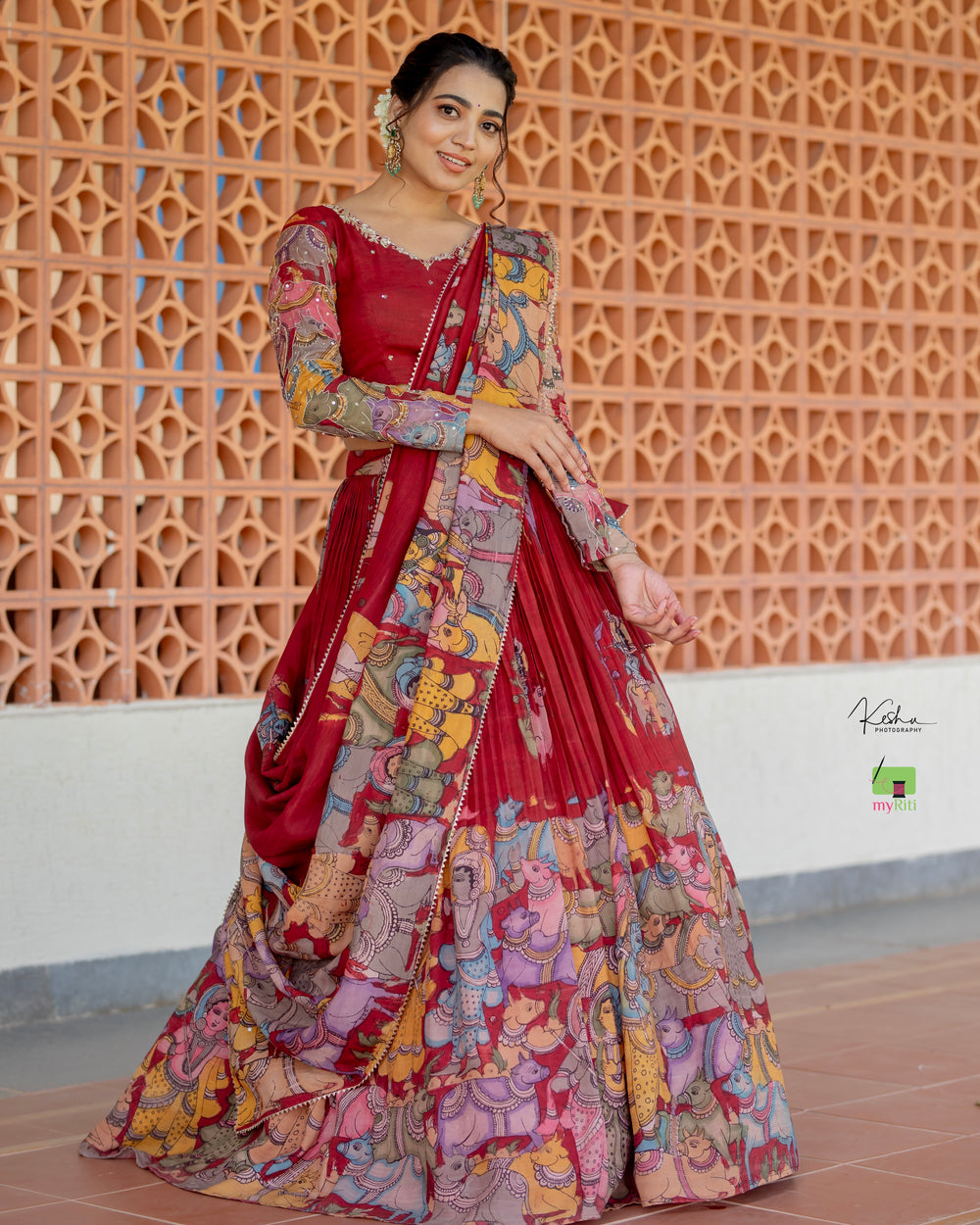 Traditional Maroon Kalamkari Lehenga paired with a matching Maroon Dupatta, featuring intricate hand-painted designs, available at MyRiti. Ideal for those seeking elegant and culturally rich online lehengas.