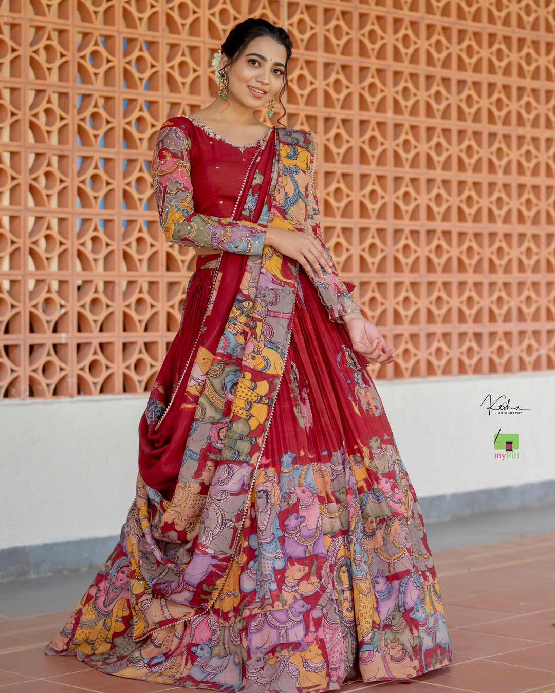 Traditional Maroon Kalamkari Lehenga paired with a matching Maroon Dupatta, featuring intricate hand-painted designs, available at MyRiti. Ideal for those seeking elegant and culturally rich online lehengas.