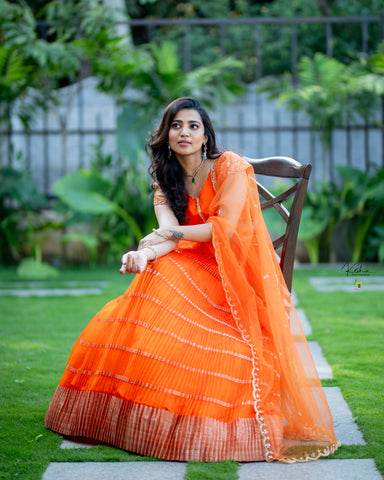 Breathtaking Orange Organza Lehenga from MyRiti, perfect for those seeking vibrant and elegant Indian wear online. This lehenga combines traditional craftsmanship with contemporary style.