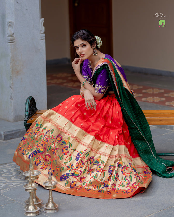 Radiant Red Paithani Lehenga, adorned with exquisite patterns, available at www.myriti.com. A perfect blend of traditional elegance and modern style, ideal for those who love the timeless beauty of Paithani Lehengas.