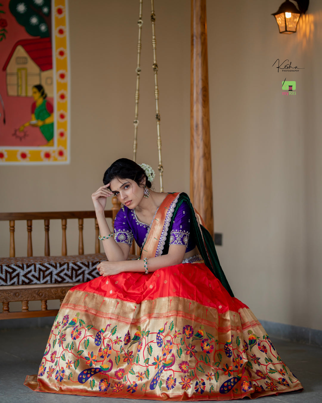 Radiant Red Paithani Lehenga, adorned with exquisite patterns, available at www.myriti.com. A perfect blend of traditional elegance and modern style, ideal for those who love the timeless beauty of Paithani Lehengas.