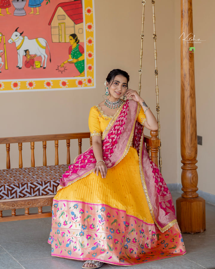 Vibrant Yellow Paithani Lehenga paired with a contrasting Blue Dupatta, showcasing exquisite craftsmanship, available at MyRiti. Ideal for adding a touch of traditional elegance to any special occasion.