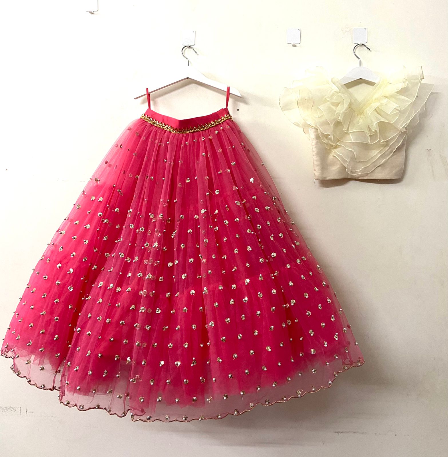 Hypnotizing Cream and Pink Net Designer Lehenga Choli at best price in Delhi