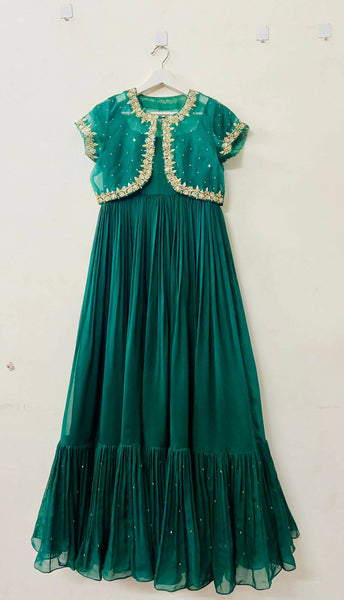 Stunning handcrafted green gown with intricate detailing, perfect for women seeking elegance and style.