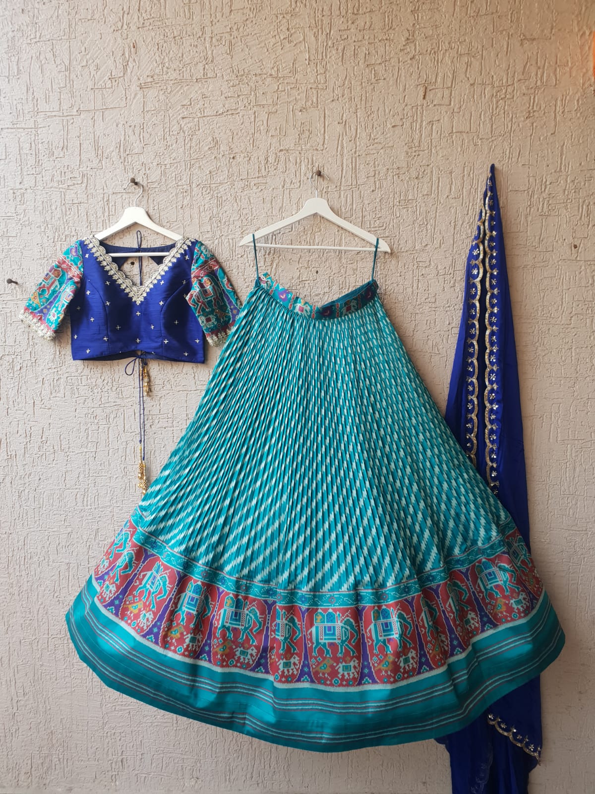 Stunning Blue and Teal Patola Silk Lehenga featuring intricate traditional patterns, ideal for women seeking a blend of cultural elegance and modern party wear.